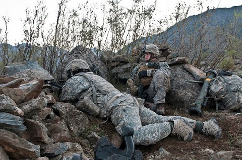 Just minutes before an eight-hour firefight, U.S. Army Spc. Nathan Allen (right), an infantry team leader from Atlantic, Iowa, and U.S. Army Pvt. Cody M. Meidinger, a squad automatic weapon machine gunner from Emporia, KS, scan the horizon from their fighting position on a remote hilltop in the Shal Valley in eastern Afghanistan's Nuristan Province Nov. 7th. (Photo by U.S. Army Staff Sgt. Mark Burrell, 210th Mobile Public Affairs Detachment)