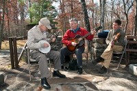 Former CCC worker Ben Hutcherson playing his homemade banjo with Bob Fulcher and Brian Vollmer of Cumberland Trail State Park.  The trio entertained the crowd at Pickett State Park’s dedication of the new Civilian Conservation Corps Museum. (Photo by Terry Bonham)