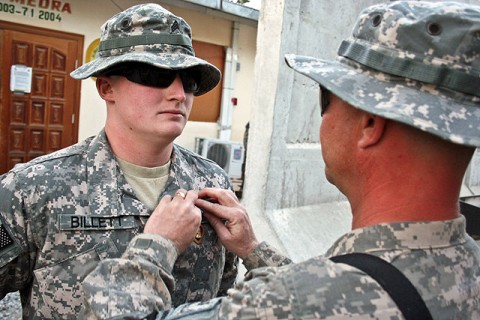 U.S. Army Sgt. William Billett (right), an infantryman with Company B, 2nd Battalion, 506th Infantry Regiment, pins the Purple Heart on the chest of his son, U.S. Army Sgt. Timothy Billett, a military policeman from Headquarters and Headquarters Company, 1st Special Troops Battalion, Thanksgiving Day on Forward Operating Base Finley Shields in eastern Afghanistan.  (Photo by U.S. Army Staff Sgt. Ryan C. Matson, Task Force Bastogne Public Affairs)