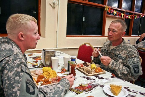 U.S. Army Sgt. William Billett (right), an infantryman with Company B, 2nd Battalion, 506th Infantry Regiment, eats Thanksgiving dinner with his son, U.S. Army Sgt. Timothy Billett, a military policeman from Headquarters and Headquarters Company, 1st Special Troops Battalion, a couple hours after pinning the Purple Heart on his chest Nov. 25th on Forward Operating Base Finley Shields in eastern Afghanistan. (Photo by U.S. Army Staff Sgt. Ryan C. Matson, Task Force Bastogne Public Affairs)