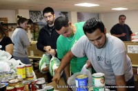 Volunteers place turkeys in individual plastic bags for easier distribution