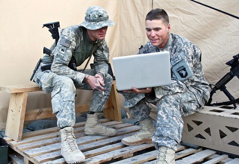 U.S. Army Sgt. Bradley J. Ragle (left), and his younger brother, U.S. Army Spc. Brandon J. V. Ragle, both of Troop A, 1st Squadron, 61st Cavalry Regiment, look at photos together on a computer outside their tent Nov. 19th at Forward Operating Base Connolly. (Photo by U.S. Army Staff Sgt. Ryan C. Matson, Task Force Bastogne Public Affairs)