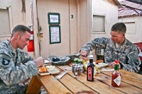 U.S. Army Sgt. Bradley J. Ragle (left), and his younger brother, U.S. Army Spc. Brandon J. V. Ragle, both of Troop A, 1st Squadron, 61st Cavalry Regiment, eat lunch together outside the dining facility Nov. 16th at Forward Operating Base Connolly. (Photo by U.S. Army Staff Sgt. Ryan C. Matson, Task Force Bastogne Public Affairs)