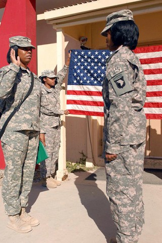 U.S. Army 1st Lt. Lasherdo Harris, brigade personnel assistant officer, from Houston, Texas, reenlists Spc. Brittany Burns from Memphis, TN, Headquarters and Headquarters Company, 3rd Brigade Combat Team, 101st Airborne Division, Nov. 10th. (U.S. Army Photo by Pfc. Chris McKenna, Task Force Rakkasan Public Affairs)