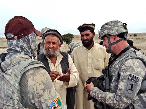 U.S. Army Staff Sgt. Robert Pharris (right), a ruminant specialist with the Khogyani District Agricultural Development Team attached to Company D, 1st Battalion, 138th Infantry Regiment from Mansfield, MO, talks with farmers in the town of Rodat.  (Courtesy photo)