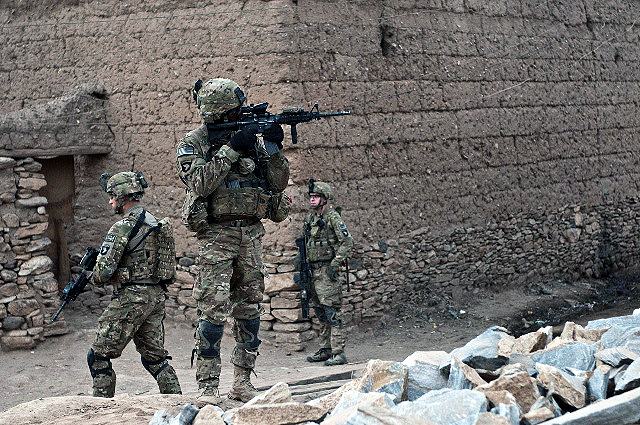 A Jamaican native, U.S. Army Staff Sgt. McCarthy Phillip (center), an infantry squad leader who resides in Decatur, GA, assigned to Company C, 1st Battalion, 327th Infantry Regiment, Task Force Bulldog, and other Soldiers patrol in a small village in the Pech River Valley in eastern Afghanistan’s Kunar Province Nov. 20th. (Photo by U.S. Army Staff Sgt. Mark Burrell, Task Force Bastogne Public Affairs Office)