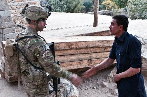 As the sun begins to rise, U.S. Army 1st Lt. Alex R. Pruden, a platoon leader from Tuscon, Ariz., assigned to Company C, 1st Battalion, 327th Infantry Regiment (Task Force Bulldog), 101st Airborne Division, shakes hands and chats with locals during a patrol in the Pech River Valley in eastern Afghanistan's Kunar Province Nov. 20th. (Photo by U.S. Army Staff Sgt. Mark Burrell, Task Force Bastogne Public Affairs)