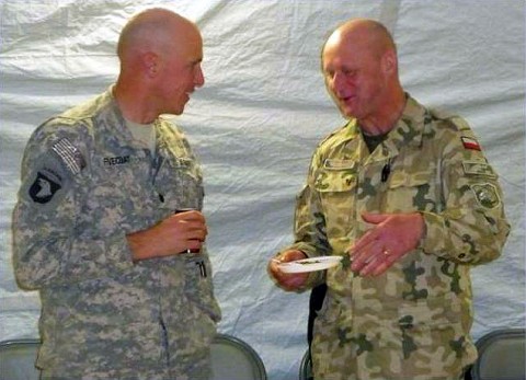 U.S. Army Lt. Col. David Fivecoat (left) from Delaware, Ohio, commander of 3rd Battalion, 187th Infantry, shares a conversation with Brig. Gen. Andrezej Reudowica, Polish Brigade Commander. Fivecoat attended the Polish Independence Day celebration as an opportunity to show respect for the Polish partners. The two men shared conversation and traditional Polish food. (Photo by U.S. Army Staff Sgt. Derek Dosedel, Task Force Iron Rakkasan)