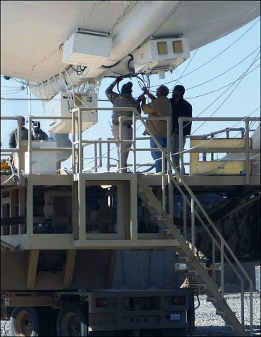 Members of the Precision Threat Detection System crew work on the final touches of the blimp’s camera systems before launching the balloon for its first flight from Forward Operating Base Andar Nov. 17th. The PTDS provides an “eye in the sky” that gives Soldiers a clear view of the surrounding area and allows better visibility of the district. (U.S. Army courtesy photo)