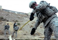 U.S. Army Spc. Tobin Hartshorn, a mortarman from Littleton, NH, (right) and U.S. Army Sgt. 1st Class Lincoln Barbieri, a mortar platoon sergeant, and St. Albans, VT, resident, measure the width of a river while U.S. Army Sgt. 1st Class Todd Gagnon, a platoon sergeant from Alexandria, NH, looks on as the Soldiers prepare to construct a bridge Nov. 7th. (Photo by U.S. Army Staff Sgt. Whitney Hughes, Task Force Wolverine Public Affairs, 86th Infantry Brigade Combat Team)