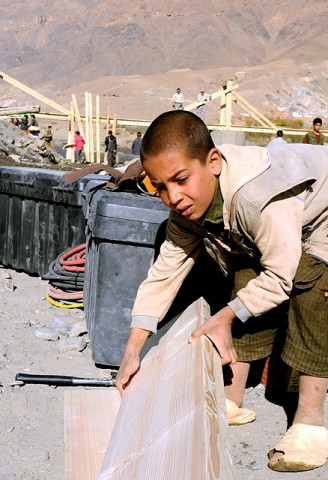 A child from Ghorband District helps construct a bridge Soldiers from the 2nd and Mortar Platoons of Troop A, 1st Squadron, 172nd Cavalry Regiment built for the residents of Ghorband District and finished Nov. 10th. (Photo by U.S. Army Staff Sgt. Whitney Hughes, Task Force Wolverine Public Affairs, 86th Infantry Brigade Combat Team)