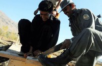 An Afghan National Policeman helps construct a bridge Nov. 7th with Soldiers from the 2nd and Mortar Platoons of Troop A, 1st Squadron, 172nd Cavalry Regiment, for the residents of Ghorband District. (Photo by U.S. Army Staff Sgt. Whitney Hughes, Task Force Wolverine Public Affairs, 86th Infantry Brigade Combat Team)