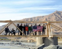 Soldiers from the 2nd and Mortar Platoons of  Troop A, 1st Squadron, 172nd Cavalry Regiment stand atop a bridge they built for the residents of Ghorband District. (Photo by U.S. Army Staff Sgt. Whitney Hughes, Task Force Wolverine Public Affairs, 86th Infantry Brigade Combat Team)