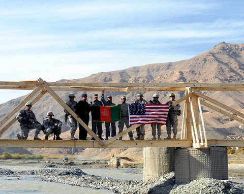 Soldiers from the 2nd and Mortar Platoons of Troop A, 1st Squadron, 172nd Cavalry Regiment stand atop a bridge they built for the residents of Ghorband District. (Photo by U.S. Army Staff Sgt. Whitney Hughes, Task Force Wolverine Public Affairs, 86th Infantry Brigade Combat Team)