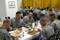 Soldiers enjoy Thanksgiving dinner with U.S. Army Col. Viet Luong from Fort Campbell, KY, and U.S. Army Command Sgt. Maj. Greg Patton from Vincennes, IN, commander and command sergeant major, respectively, of 3rd Brigade Combat Team (Task Force Rakkasan), 101st Airborne Division, at Forward Operating Base Salerno Nov. 25th. (U.S. Army photo by Staff Sgt. Andrew Guffey, Task Force Rakkasan Public Affairs)