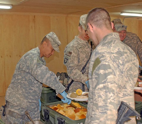 U.S. Army Col. Viet Luong, 3rd Brigade Combat Team, 101st Airborne Division commander, from Fort Campbell, KY, serves Christmas food to Soldiers and Airmen with 1st Battalion, 187th Infantry Regiment in Bak, Afghanistan, Dec. 25th. (U.S. Army Photo by Pfc. Chris McKenna)