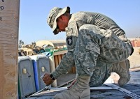 A McQueeney, Texas, native, U.S. Army Spc. Garrett Bartlett, Troop D, 1st Squadron, 61st Cavalry Regiment, secures the load on his light medium tactical vehicle trailer with cargo straps Nov. 17th at Forward Operating Base Fenty before taking the drive back to FOB Connolly. (Photo by U.S. Army Staff Sgt. Ryan C. Matson, Task Force Bastogne Public Affairs)