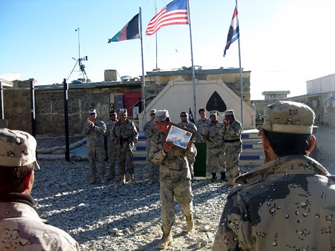 An Afghan Border Policeman accepts his diploma during a graduation ceremony for the Red Currahee Team Leader Course taught by Company D, 1st Battalion, 506th Infantry Regiment, 101st Airborne Division on Forward Operation Base Waza Kwah Dec. 13th. (Photo by U.S. Army 1st Sgt. Brian D. Gemmil, Company D, 1st Battalion, 506th Infantry Regiment, 4th Brigade Combat Team, 101st Airborne Division)