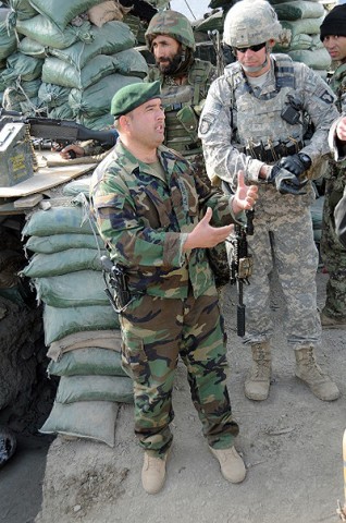 Afghan National Army Capt. Rohullah, company commander of 4th Coy, 1st Kandak, 2nd Brigade, 201st Corps, and U.S. Army Capt. Michael Gansler, Troop C commander, 1st Squadron, 32nd Cavalry Regiment, 1st Brigade Combat Team, 101st Airborne Division discuss the transfer of Observation Post Mace to the ANA Dec. 20th. (Photo by U.S. Air Force Capt. Peter Shinn, Task Force Bastogne)