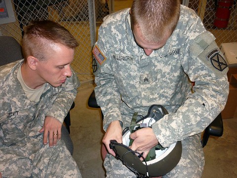 U.S. Army Sgt. Phillip Wiglesworth of Lenexa, KS, shows U.S. Army Sgt. Anthony Jett of Warrensburg, MI, how to install the Hearthru modification on a helmet used by flight crews. Both Soldiers are noncommissioned officers working in the aviation life support shop of Company D, 3rd Battalion, Task Force Phoenix, 10th Combat Aviation Brigade, 10th Mountain Division. (Photo by U.S. Army Sgt. Buck Atkin, Task Force Phoenix)