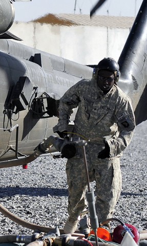 Spc. Clyde Tyrone Adams, Jr., E Troop, Task Force Saber petroleum supply specialist finishes fueling a UH-60 Black Hawk helicopter Nov. 30th,2010 at Forward Operating Base Wilson, Afghanistan. (Photo by Spc. Tracy Weeden)