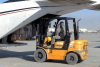 U.S. Army Spc. David Casper of Chesapeake, VA, a parachute rigger with the 82nd Sustainment Brigade, 82nd Airborne Division, loads supplies and gifts for forward operating bases onto an airplane at Bagram Airfield Dec. 22nd. FOBs that have limited supplies and amenities received the supplies, which included food and basic essentials. (Photo by U.S. Army Spc. Adam L. Mathis, 17th Public Affairs Detachment)