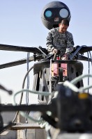 Pvt. Rueden Alivio, D Troop, TF Saber OH-58D Kiowa Warrior helicopter repairer rigs an aircraft during sling load training Dec. 2nd, 2010 at Kandahar Airfield, Afghanistan. (Photo by Spc. Tracy Weeden)