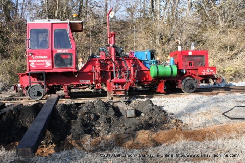 One of the RJ Corman tie extractor/inserter machines putting a new railroad cross-tie into place.