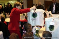 Annette Kalinowski from F&M Bank helps distribute the gifts to children