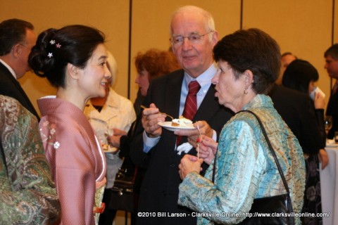 Yoko Sato speaks with guests at the celebration of the Emperor's birthday 