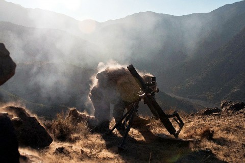 U.S. Army Spc. Corey C. Canterbury, a mortarman from Ocean Springs, MS, assigned to Company B, 2nd Battalion, 327th Infantry Regiment, Task Force No Slack, 1st Brigade Combat Team, 101st Airborne Division, kneels down after firing a mortar round on a mountainside overlooking the Ganjgal Valley in eastern Afghanistan Dec. 11th. (Photo by U.S. Army Staff Sgt. Mark Burrell, Task Force Bastogne Public Affairs)