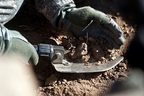 U.S. Army Spc. Joshua R. Wood, a mortar man from Pontotoc, MS, assigned to Bayonet Company, 2nd Battalion, 327th Infantry Regiment, Task Force No Slack, uses his entrenching tool to fill sandbags for his fighting position on a mountainside overlooking the Ganjgal Valley in eastern Afghanistan’s Kunar Province Dec. 10th. (Photo by U.S. Army Staff Sgt. Mark Burrell, Task Force Bastogne Public Affairs)