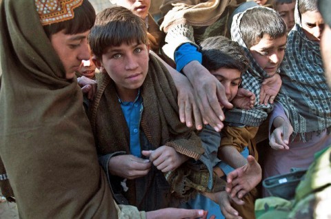 Afghan boys crowd each other to get a piece of candy handed out by Afghan National Army combat medics outside the Mannakhil Comprehensive Health Care Center in Sherzad District in eastern Afghanistan’s Nangarhar Province Dec. 26th. (Photo by U.S. Army Staff Sgt. Mark Burrell, Task Force Bastogne Public Affairs)