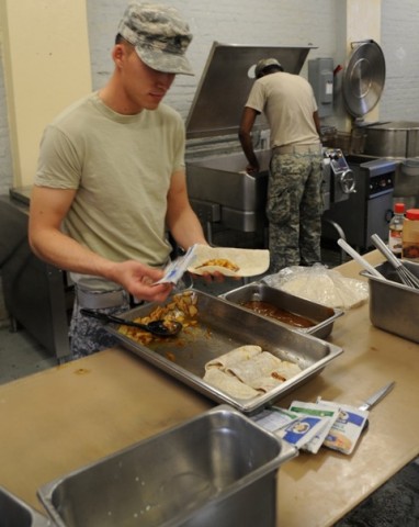 U.S. Army Sgt. Aaron E. Shishido of La Habra, CA, a food service noncommissioned officer from Company E, 1st Battalion, 506th Infantry Regiment, 4th Brigade Combat Team, 101st Airborne Division, assembles the ingredients for apple turnovers, a special treat for Soldiers at Forward Operating Base Waza Khaw Nov. 24th. (U.S. Army photos by Spc. Kimberly K. Menzies, Task Force Currahee Public Affairs)