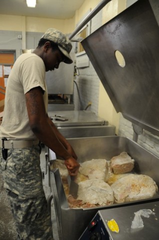 U.S. Army Pfc. Ailea N. Hundley of Chicago, a food service specialist from Company E, 1st Battalion, 506th Infantry Regiment, 4th Brigade Combat Team, 101st Airborne Division, and begins to grill chicken for fajitas as part of the Mexican food menu at Forward Operating Base Waza Khaw Nov. 24th. (Photos by U.S. Army Spc. Kimberly K. Menzies, Task Force Currahee Public Affairs)