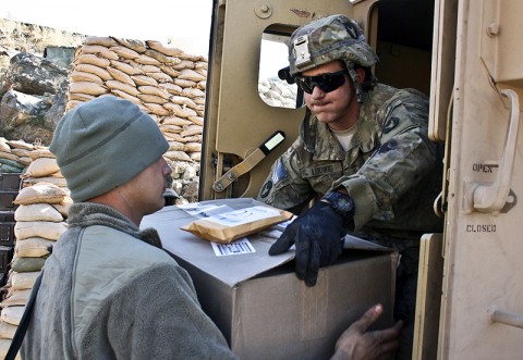 U.S. Army Spc. Anthony Ludwig (right) from Farley, Iowa, and U.S. Army Pfc. Jayson Vandeneinde from St. Petersburg, FL, both infantryman with Company A, 1st Battalion, 133rd Infantry Regiment, unload holiday mail Dec. 24th at Combat Outpost Najil. (Photo by U.S. Army Staff Sgt. Ryan C. Matson, Task Force Red Bulls Public Affairs)