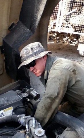 U.S. Army Spc. Thomas Floyd, wheeled vehicle mechanic, 2nd Battalion, 320th Field Artillery Regiment, repairs an armored vehicle in his motor pool on Forward Operating Base Hughie Dec. 20th. Floyd, a Colton, OR, native, is on his second deployment to Southwest Asia. (Photo by U.S. Army Spc. Tommy Porter, 2nd Battalion, 320th Field Artillery Regiment)