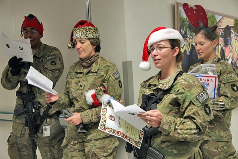 U.S. Army Sgt. Harold Dudley (far left), U.S. Army Capt. Martha Kester (left), U.S. Army 1st Lt. Cecelia Anderson (center) , 1st Lt. Sarah Droll (back), sing Christmas carols for the staff and patients Staff Sgt. Heathe N. Craig Joint Theater Hospital Dec. 24th. (Photo by U.S. Army Spc. Kristina L. Gupton, Task Force Red Bulls Public Affairs)