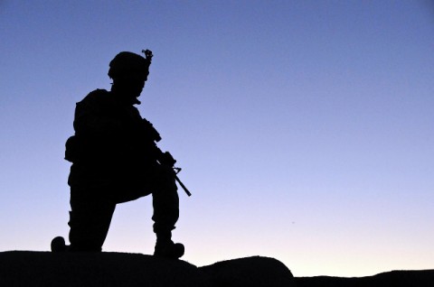 A Soldier from Headquarters and Headquarters Company, 1st Battalion, 506th Infantry Regiment, 4th Brigade Combat Team, 101st Airborne Division kneels in an over-watch position on top of a qualot wall during their last deployment. (Photo by Spc. Luther L. Boothe Jr., Task Force Currahee Public Affairs Office)