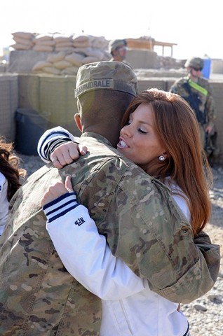 Dallas Cowboys cheerleader Brandi Redmond gives a hug to a Soldier from 4th Brigade Combat Team, 10th Mountain Division’s Task Force Patriot during a USO tour at Forward Operating Base Shank Dec. 21st. (Photo by U.S. Army Spc. Brian P. Glass, Task Force Patriot Public Affairs)