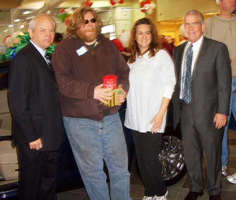 Jay Kleiss, second from left, winner of a 2010 Suzuki Kizashi, is congratulated by Mr. O. B. Garland, Managing Partner of Mathews Suzuki;  C C Carmack and Tom Todd, regional Suzuki representative.