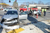 Officer Leo Kryszewski checking the crashed vehicle and firefighters at scene.