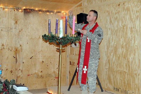 U.S. Army Chaplain (Maj.) Randal H. Robison of Grand Prairie, Texas, brigade chaplain for 4th Brigade Combat Team, 101st Airborne Division, lights the Advent candles during a Catholic mass at the Frontline Chapel at Forward Operating Base Sharana Dec. 24th. (Photo by U.S. Army Sgt. Luther L. Boothe Jr., Task Force Currahee Public Affairs)