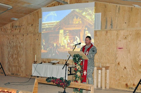 U.S. Army Chaplain (Maj.) Randal H. Robison, 101st Airborne Division, recites the story of the nativity scene and the night of Jesus Christ’s birth during a Protestant service at the Frontline Chapel at Forward Operating Base Sharana Dec. 24th. (U.S. Army Photo by Sgt. Luther L. Boothe Jr., Task Force Currahee Public Affairs)