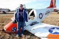 Robert B. Eley stands before his crashed aircraft