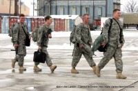 A soldier grins as he sights his family waiting on the tarmac for his return.