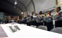 A table decoration with Dr. Martin Luther King Jr.’s photo sits as service members wait in line for breakfast during a series of series of event s held to honor Dr. King on Bagram Airfield, Afghanistan, Jan. 17th. (Photo by U.S. Army Sgt. Scott Davis, Regional Command-East Public Affairs)