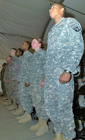 U.S. Army Sgt. Michael McReynolds stands at attention during a noncommissioned officer induction ceremony for recently promoted NCOs at Bagram Airfield Jan. 21st. McReynolds, who has served for six years in the Army, plans to stay in the Army until his retirement. (Photo by U.S. Army Spc. Adam L. Mathis, 17th Public Affairs Detachment)