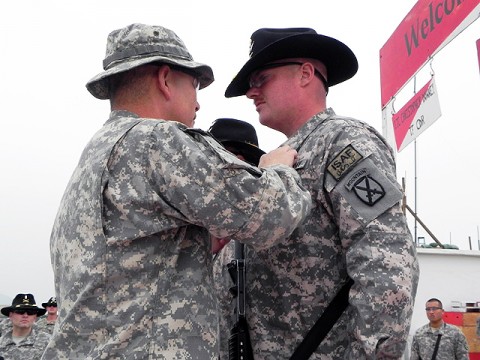 U.S. Army Spc. Matthew Riddle of Greenfield, IN, is awarded the Purple Heart by U.S. Army Maj. Gen. John F. Campbell, commander of Combined Joint Task Force 101 and Regional Command East, Dec. 30th at Jalalabad Airfield. Riddle was injured by a fragmentation grenade during the insurgent attack on Forward Operating Base Fenty Nov. 13th.  (Photo by U.S. Army Spc. Kam Gerohimos, Task Force Shooter)