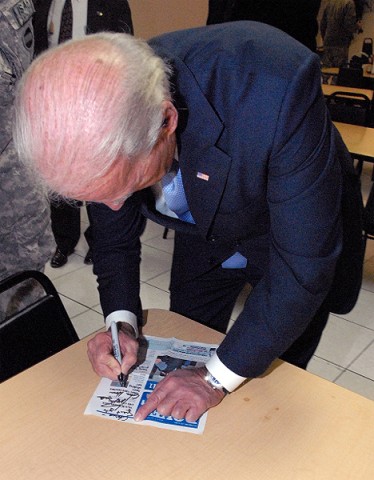 Vice President Joe Biden autographs a copy of the Dover Post for a Delaware servicemember during his visit to Bagram Airfield Jan. 12th. (Photo by U.S. Army Sgt. David House, 17th Public Affairs Detachment)